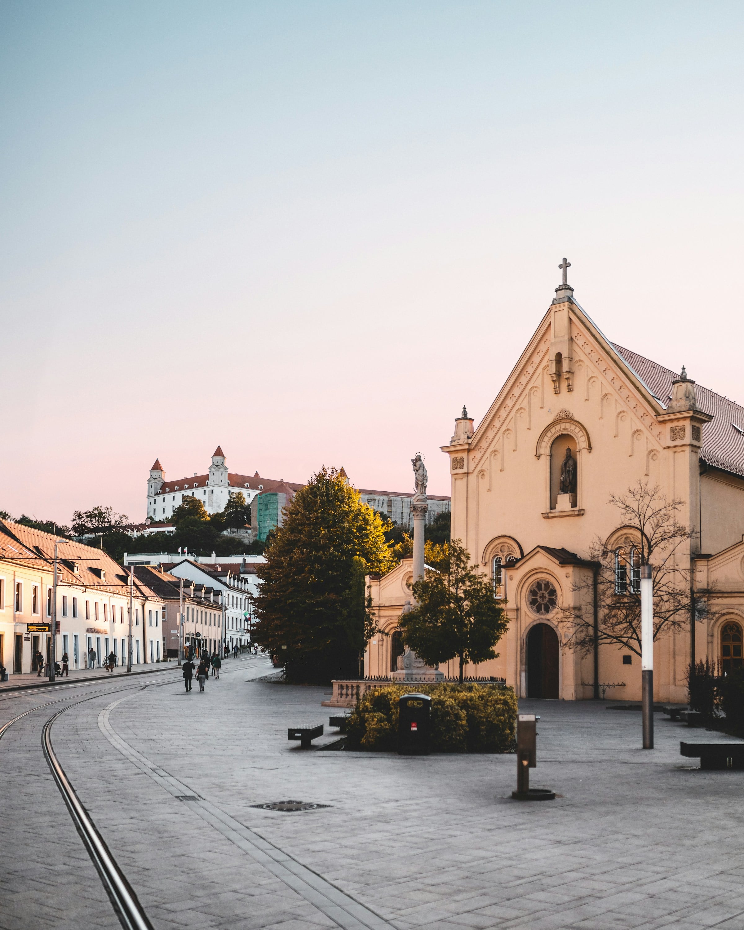Kapucínska Street at dusk with the Capuchin church and castle in the background