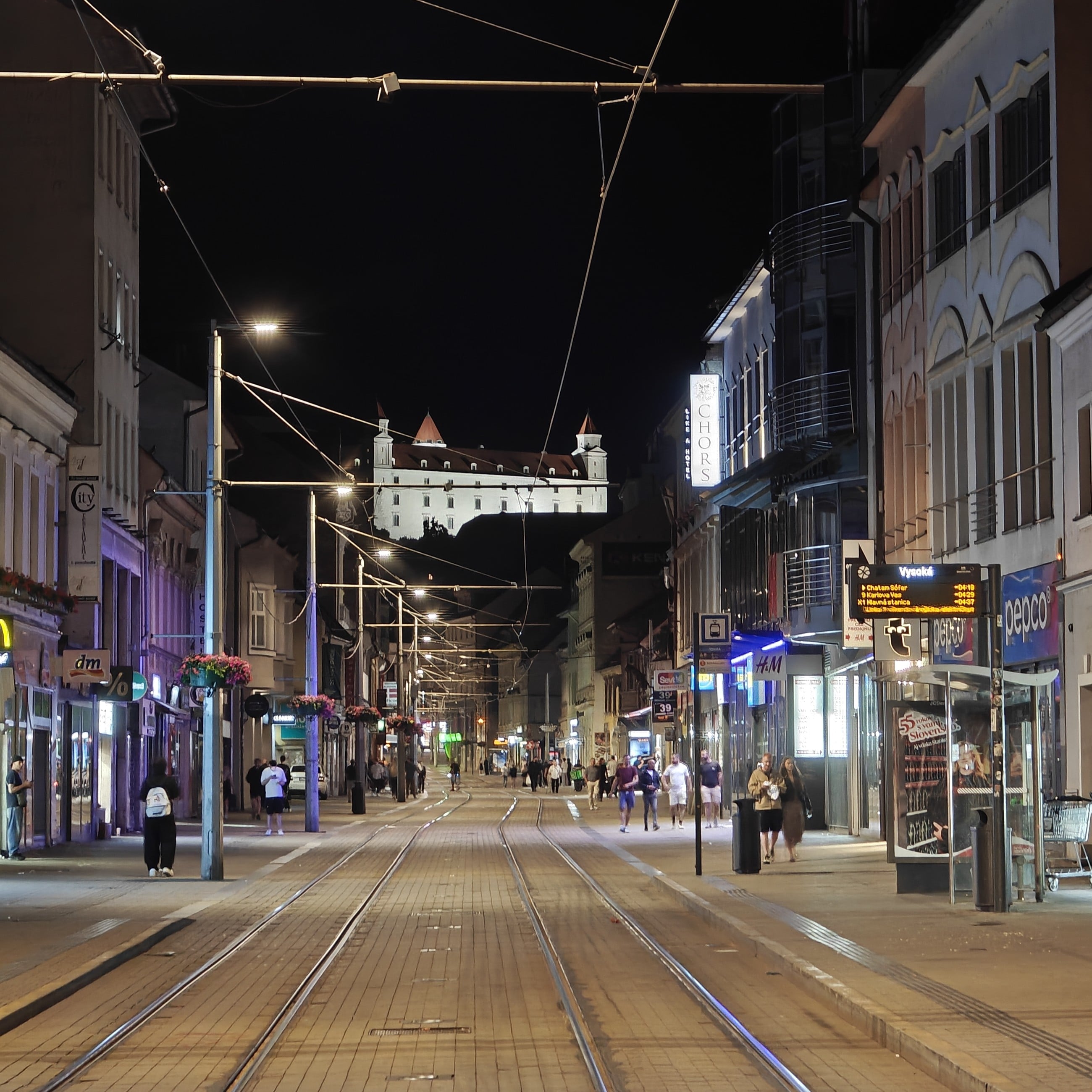 Obchodná Street at night with Bratislava Castle lit up in the background