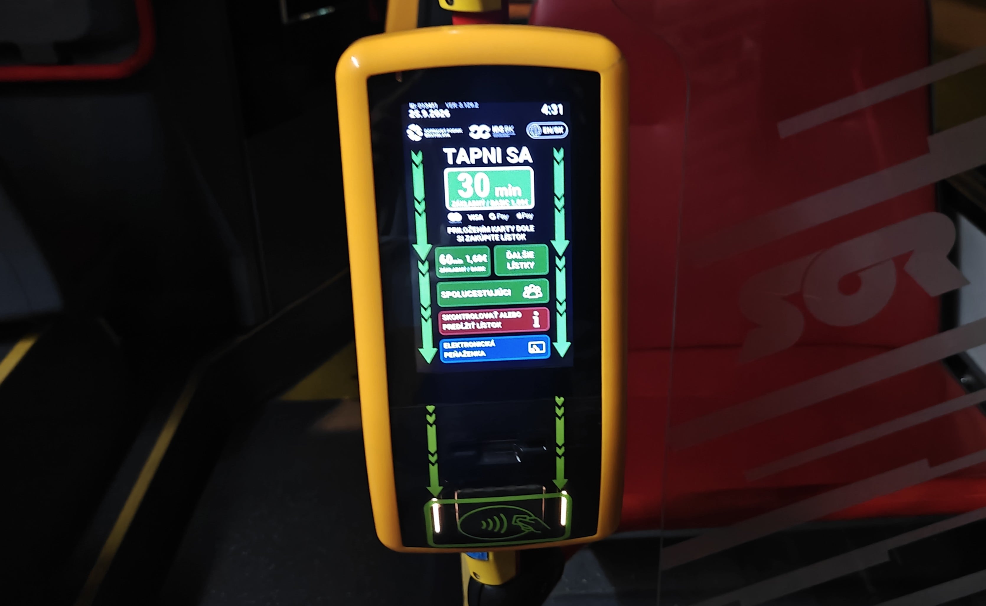 A yellow contactless ticket validator inside a Bratislava tram